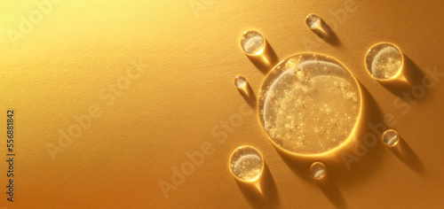 round transparent drop of clear gel serum on gold background