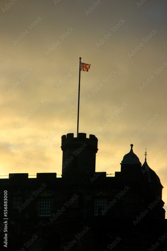 Edinburgh Castle at sunrise with the Union Jack flag in Scotland