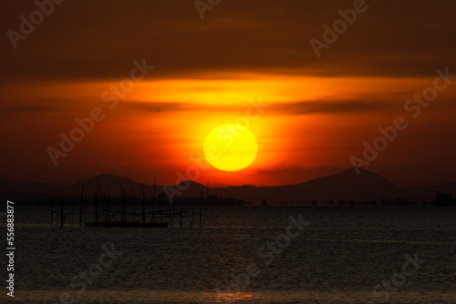 Silhouette of fish cage in the lake with Sunset sky