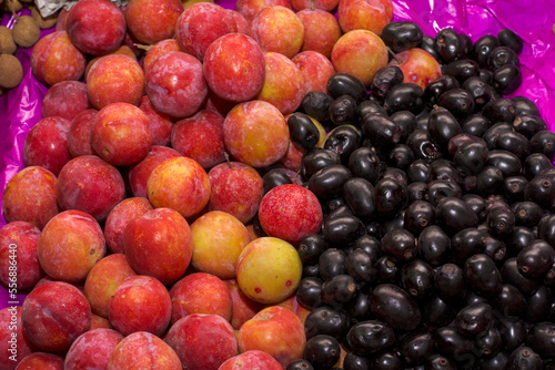 Peaches and black berries on table for sale  selective focus.