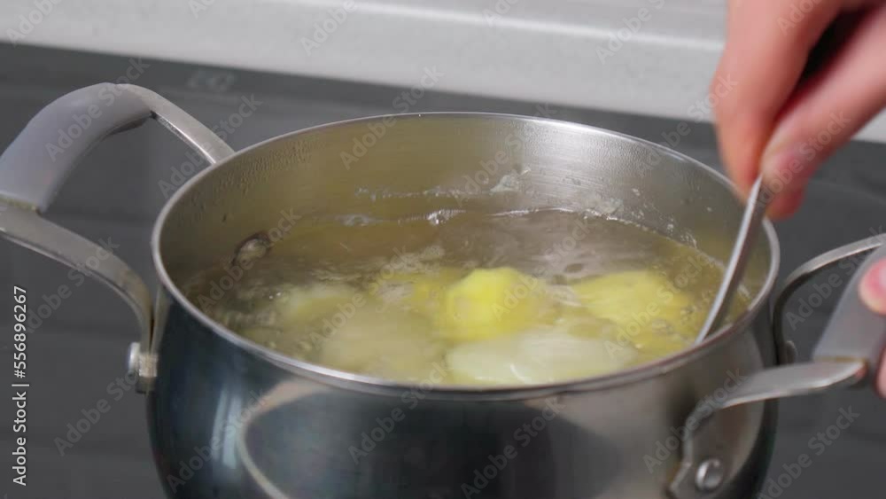 Potatoes boiling in water. Close up. Selective focus. Process of cooking Potatoes boiling in water. Close up. Selective focus. Process of cooking