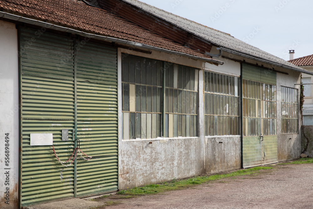 gate green old glazed facade of an old workshop facade