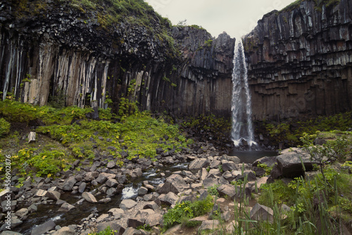 Svartifoss waterfall and river landscape photo. Beautiful nature scenery photography with cliffs on background. Idyllic scene. High quality picture for wallpaper  travel blog  magazine  article
