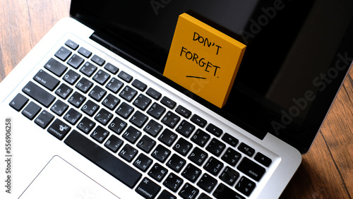 Don't forget message concept written post it on laptop.