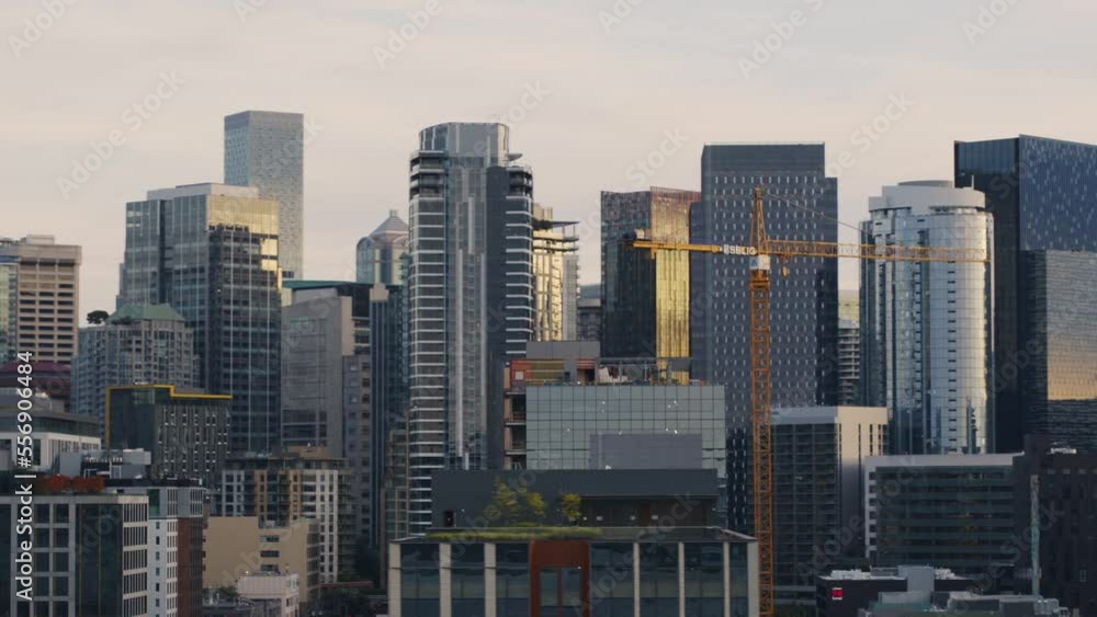 Tower crane over city among skyscrapers civil engineering project in Seattle