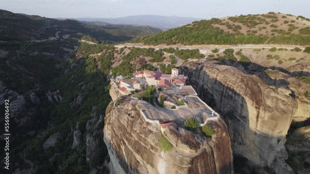 Aerial pullback from Monastery Holy Trinity on Rock hilltop Revealing Scenic canyon of Meteora, Greece Aerial pullback from Monastery Holy Trinity on Rock hilltop Revealing Scenic canyon of Meteora, Greece