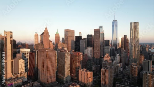 Sunlit skyscrapers in the Financial District of Manhattan, golden hour in New York - Aerial view photo