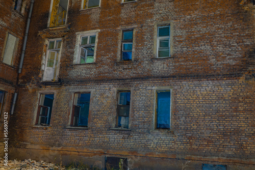 The facade of an old and destroyed brick building