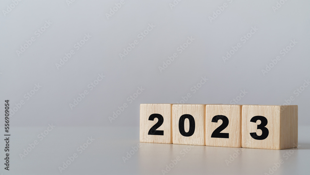 start to year 2022. wooden cube block with 2023 year text. happy new years concept. start to year 2022. wooden cube block with 2023 year text. happy new years concept.