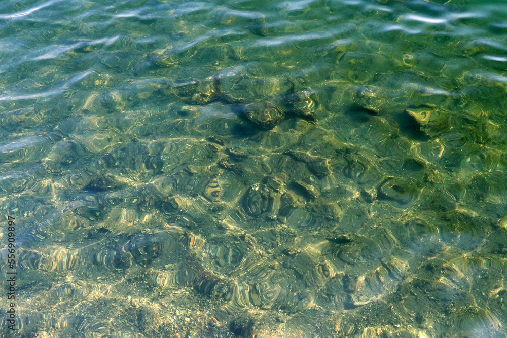 Fototapeta premium Sun shining clear water surface texture photograph.
