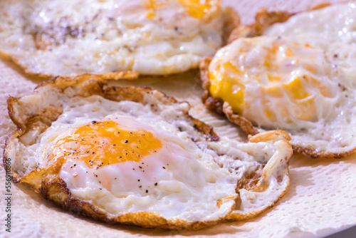 Sunny side up eggs, salted and served hot, somewhat over easy style