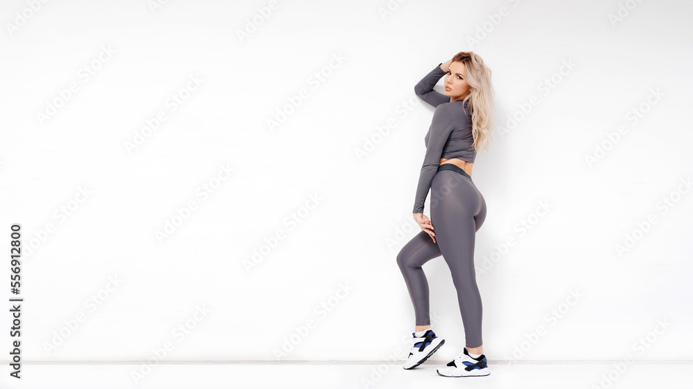 Young attractive woman posing in sportive clothes, feeling strong Young attractive woman posing in sportive clothes, feeling strong