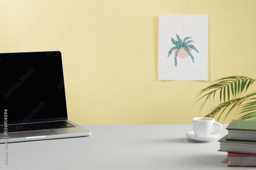 casual office desk with bright yellow background casual office desk with bright yellow background