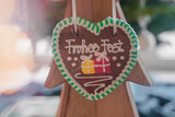 Gingerbread christmas with green cream and a close-up of a festive inscription with bokeh effect. Christmas cozy atmosphere. Festive fair. Handmade gingerbreads. Homemade cakes. Selective focus