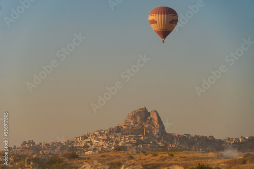 Balloon flying over Cappadocia, caves at dawn