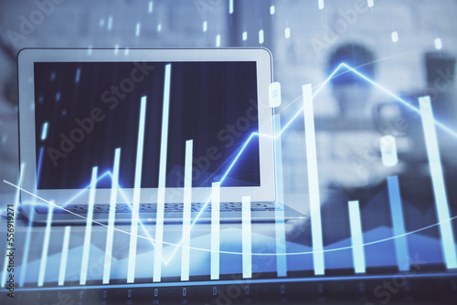 Stock market graph on background with desk and personal computer. Double exposure. Concept of financial analysis. © peshkova