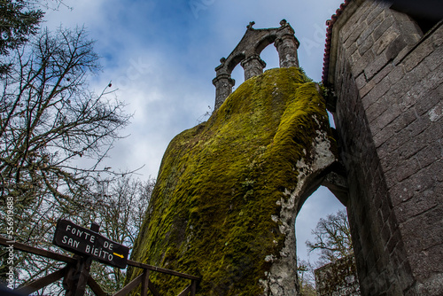beautiful and very old bell tower on a large rock covered with moss in the romanesque monastery of San Pedro de Rocas, Esgos, Ourense