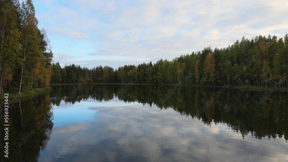 Beautiful autumn day and colorful trees. Shot in Finland. Blue sky and white clouds. Beautiful reflection. Beautiful autumn day and colorful trees. Shot in Finland. Blue sky and white clouds. Beautiful reflection.