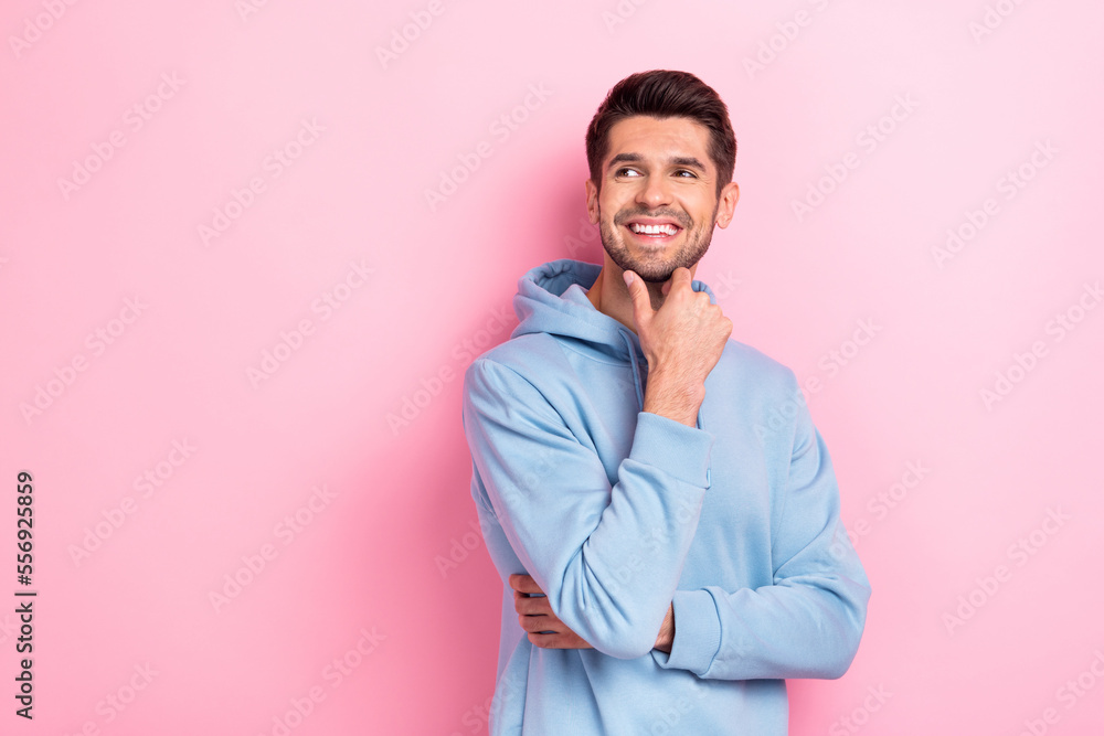 Portrait of positive glad man arm touch face interested look empty space nice offer low prices isolated on pink color background Portrait of positive glad man arm touch face interested look empty space nice offer low prices isolated on pink color background
