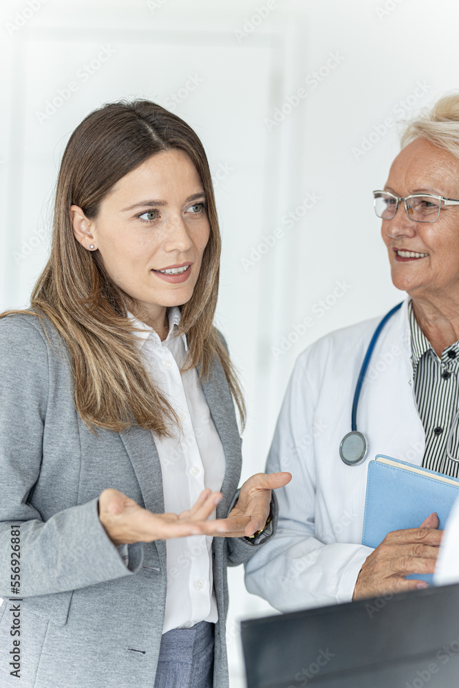 Fototapeta premium Two female doctors on business meeting with hospital management, discussing about new medical trends