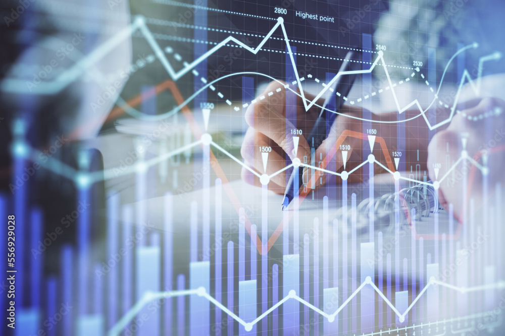 Financial forex graph displayed on hands taking notes background. Concept of research. Multi exposure Financial forex graph displayed on hands taking notes background. Concept of research. Multi exposure