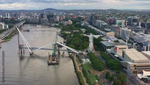Panoramic aerial view fly around Brisbane city capturing building progression of neville bonner bridge connecting south bank and central business district and the star casino queen's wharf tower. photo
