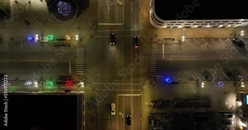 Pontiac, Michigan street corner and traffic at night with drone video moving down. photo