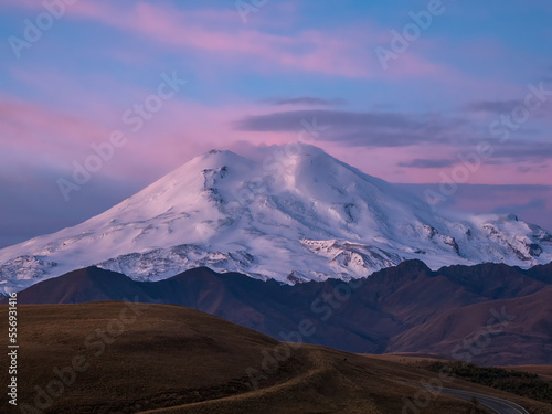 Purple majestic dawn over Mount Elbrus. Snowy mountain peaks at
