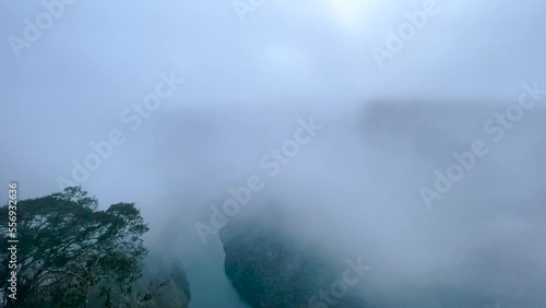 shot from a viewpoint of the sumidero canyon with intense fog towards the chicoasen river photo