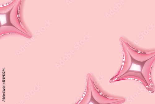 Inflatable star balloons on a pink background. Festive concept with place for text.