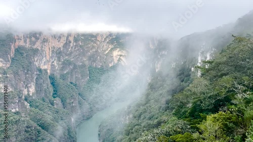 Sumidero canyon shot with clouds rushing up the canyon wall photo