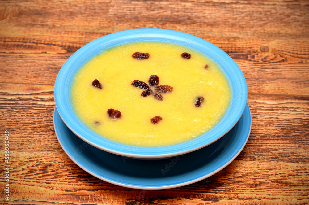 sweet maize porridge on a wooden table close-up sweet maize porridge on a wooden table close-up