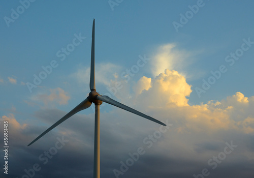 Wind turbine against cloudy sky