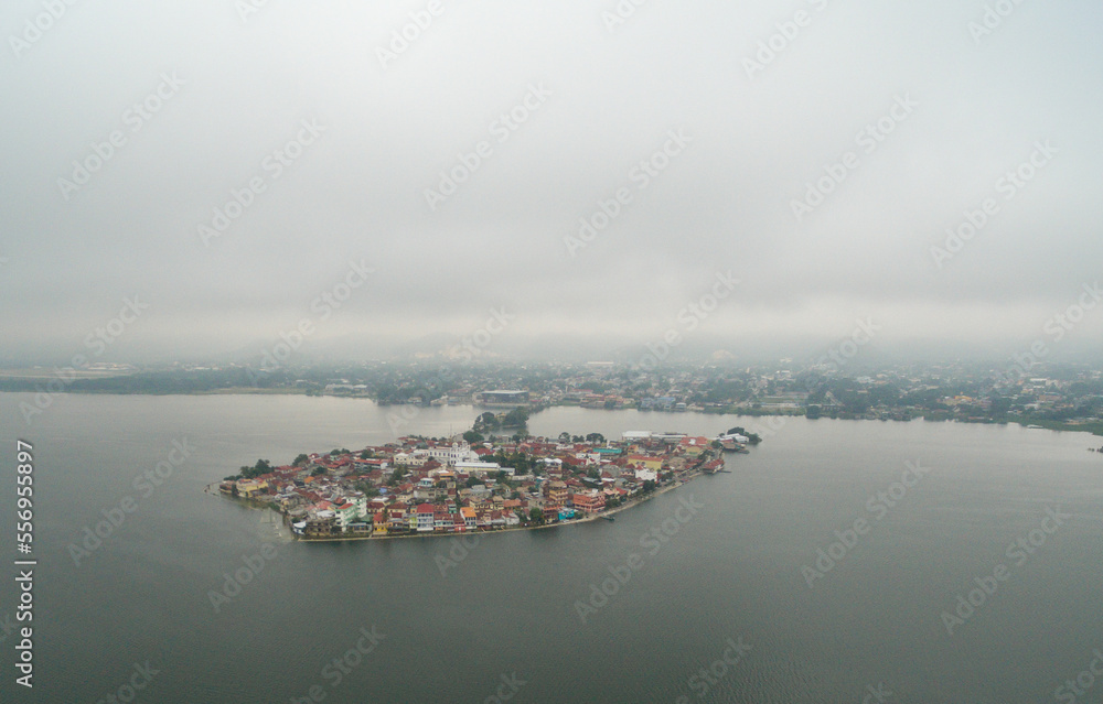 Fototapeta premium Flores island in Guatemala. Morning Misty Light with Lake Peten Itza in background