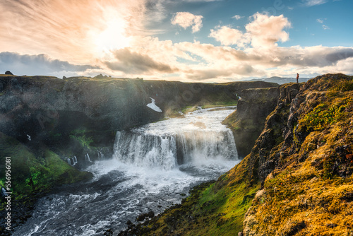 View of Axlafoss waterfall flowing in the canyon among the remote wilderness in the evening on summer at Highlands of Iceland