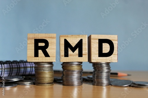 RMD concept, Required minimum distribution concept on wooden blocks.