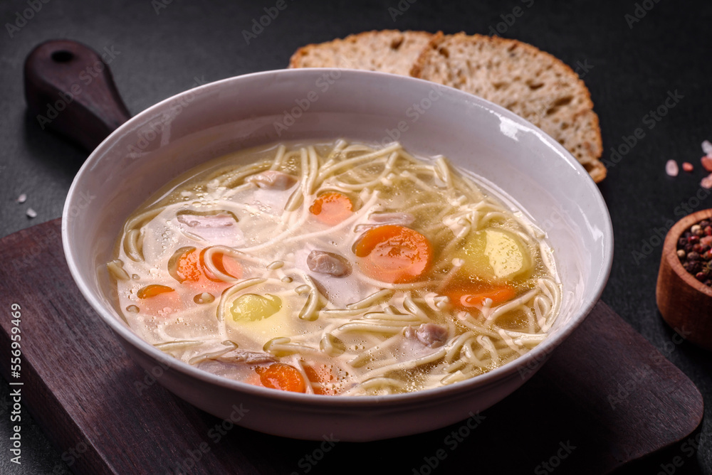 Delicious soup with noodles, chicken and carrots with spices and herbs Delicious soup with noodles, chicken and carrots with spices and herbs