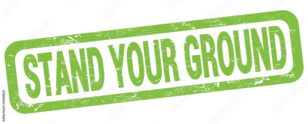 STAND YOUR GROUND text written on green rectangle stamp. STAND YOUR GROUND text written on green rectangle stamp.