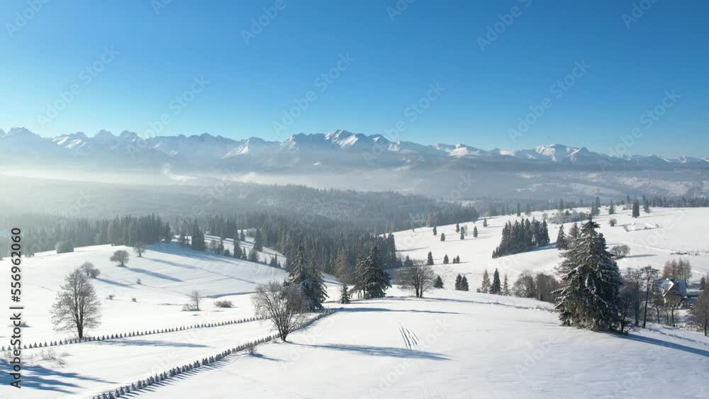 Epic alpine vista and white winter in the mountains. Aerial view of snow capped mountain landscape. Tatra high mountain range and magical unspoiled scenery with frozen spruce trees. Epic alpine vista and white winter in the mountains. Aerial view of snow capped mountain landscape. Tatra high mountain range and magical unspoiled scenery with frozen spruce trees.