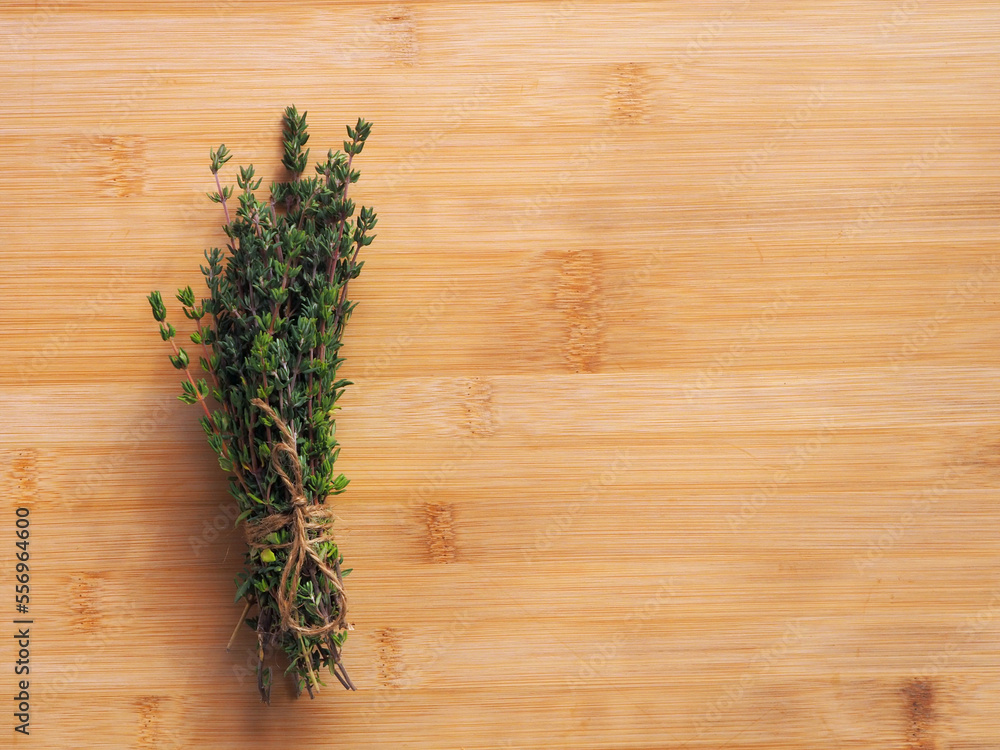 Bundle of fresh thymes on a wooden background. Bundle of fresh thymes on a wooden background.