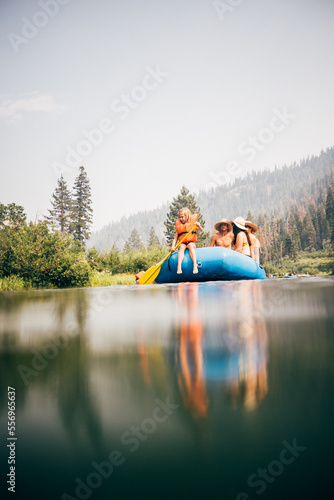 USA, California, Family rafting on calm Truckee river photo