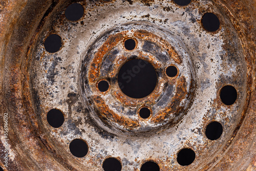 old car rim with rust close-up on a black background