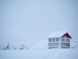Lonely red house in the snow