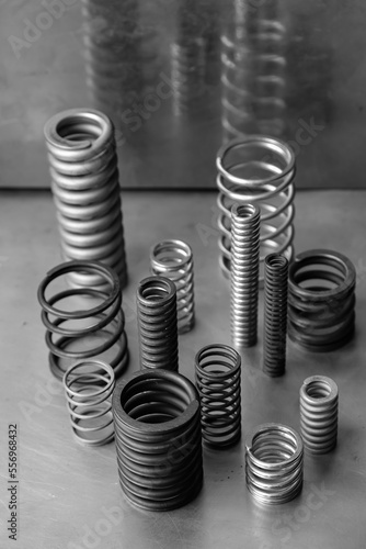 Different sizes of springs. Metal background. Black and white. 