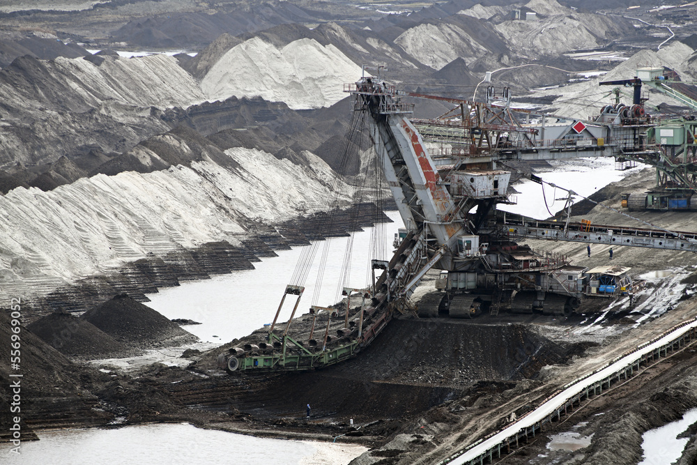 An huge excavator on a coal surface mine. Interesting geological forms of tailings dump in an open pit coal mine.	