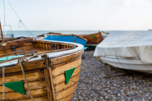 The prow of a wooden fishing boat on the beach on the English coast