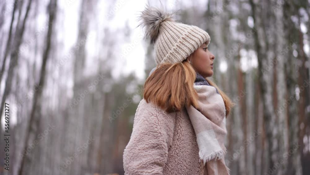Worried unsure teen girl looking around and looking at camera with anxious facial expression. Portrait of hesitating Caucasian teenager posing outdoors on winter day Worried unsure teen girl looking around and looking at camera with anxious facial expression. Portrait of hesitating Caucasian teenager posing outdoors on winter day