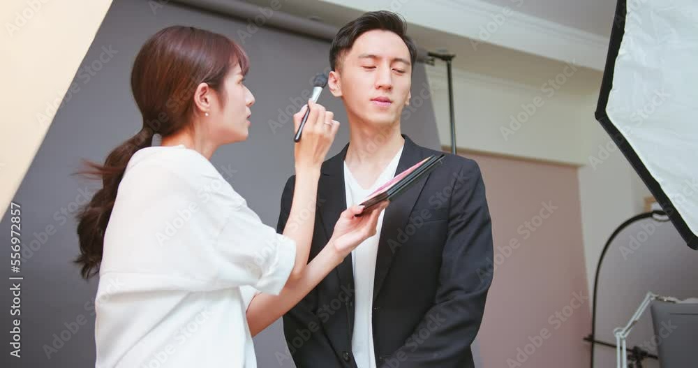 Makeup artist assists model Makeup artist assists model