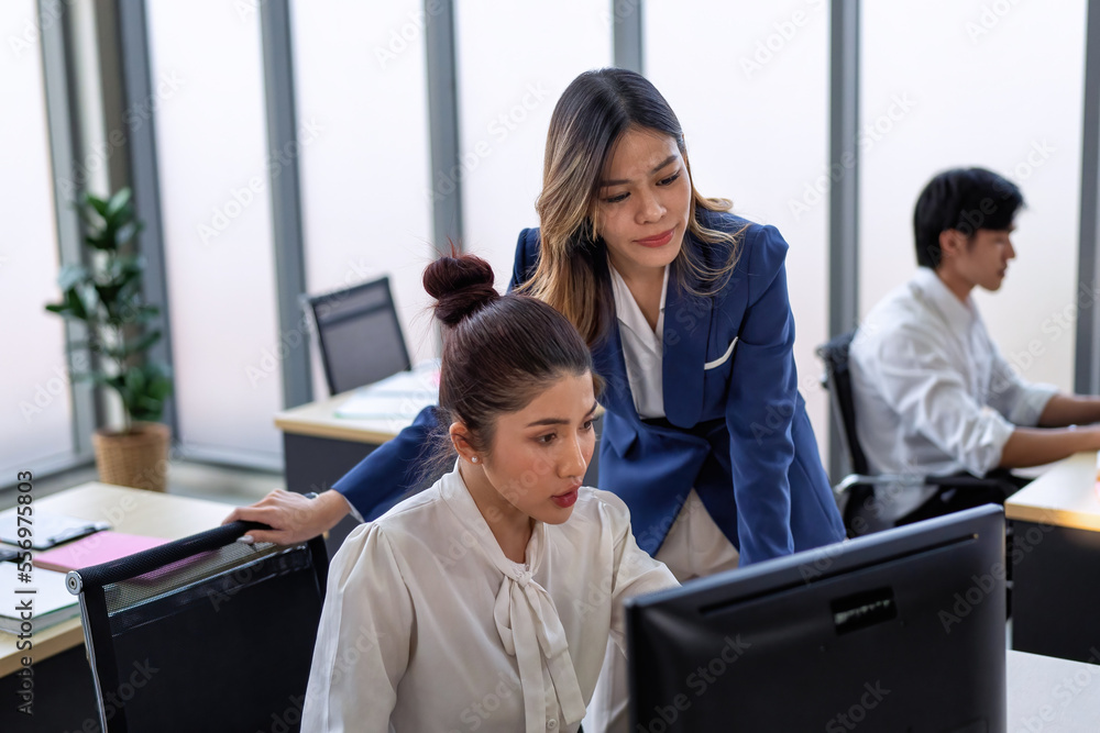 Business employee in formal suits working at table and discussing business strategy together Business employee in formal suits working at table and discussing business strategy together
