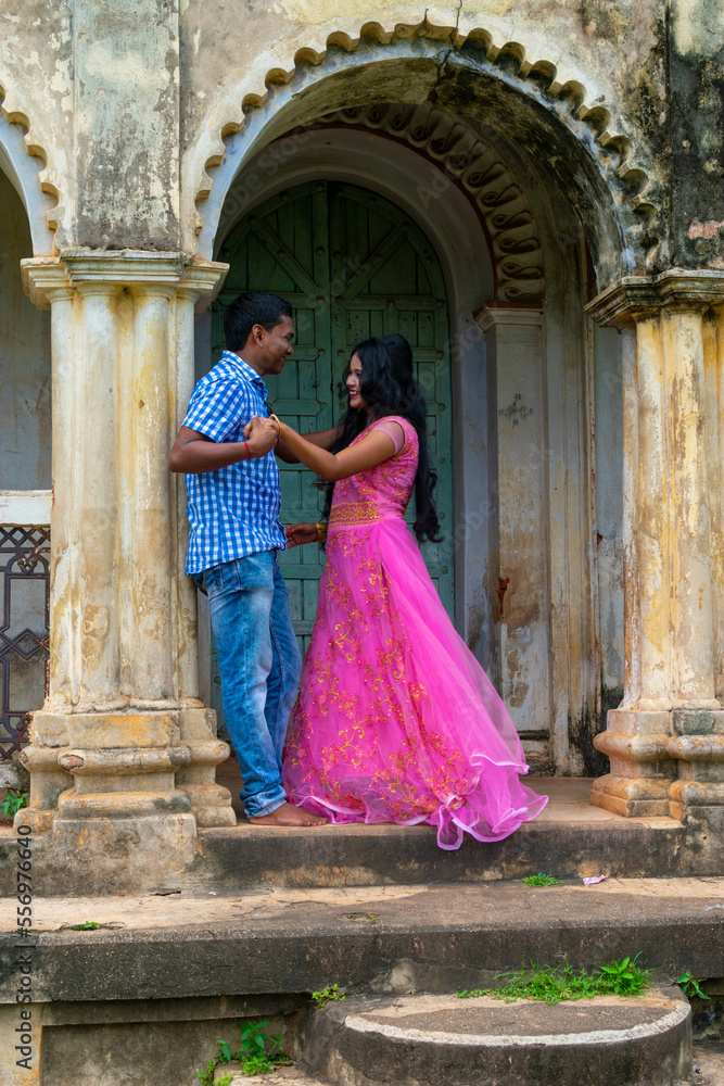 Indian couple in love enjoy a moment of happiness in old structure. Bengali couple on romantic mood. Selective focus on woman face.